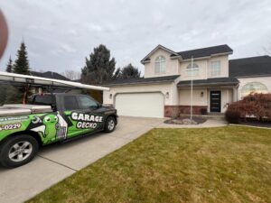A Garage Gecko service truck parked in front of a residential house for a garage door service in Spokane, WA.