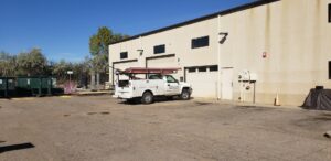 A Front Range Raynor Garage Door & Service truck parked at a commercial building for a garage door job in Fort Collins, CO.