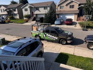 A Garage Gecko service truck parked on a residential street for a garage door service call in Spokane, WA.
