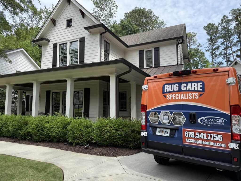 The Advanced Cleaning Systems service van parked at a modern residential house in Atlanta, GA for carpet work.