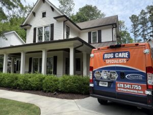 The Advanced Cleaning Systems service van parked at a modern residential house in Atlanta, GA for carpet work.