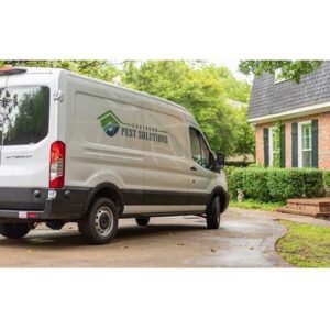 A Southern Pest Solutions Inc service van parked in front of a residential home in Raleigh, NC, ready for a pest control job