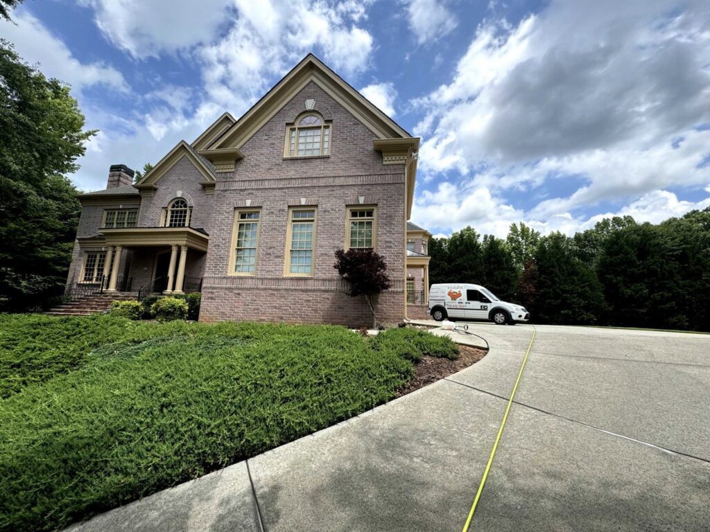 A Johns Creek Carpet Cleaner service van parked outside a large residential home for a job in Johns Creek, GA.