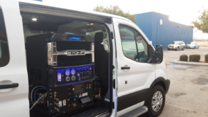 A white service van with an Everest 870HP truckmount carpet cleaning system visible inside, ready for Delmac Products Truckmount Service in Bakersfield, CA.