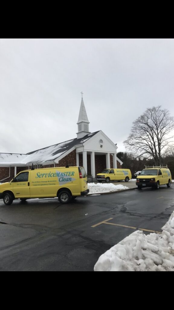 ServiceMaster Clean vans parked outside a church for commercial carpet cleaning services by ServiceMaster Albino in Waterbury, CT.