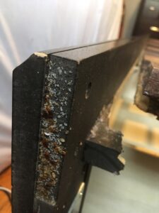A severe bed bug infestation with numerous bugs and droppings on a furniture frame, treated by Bug Bounty Hunters LLC in Akron, OH.