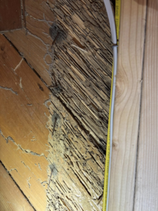 Severe termite damage on a wooden surface, showing hollowed-out and crumbling wood, indicating pest control needs for Endurance Pest Management LLC in Stillwater, OK.