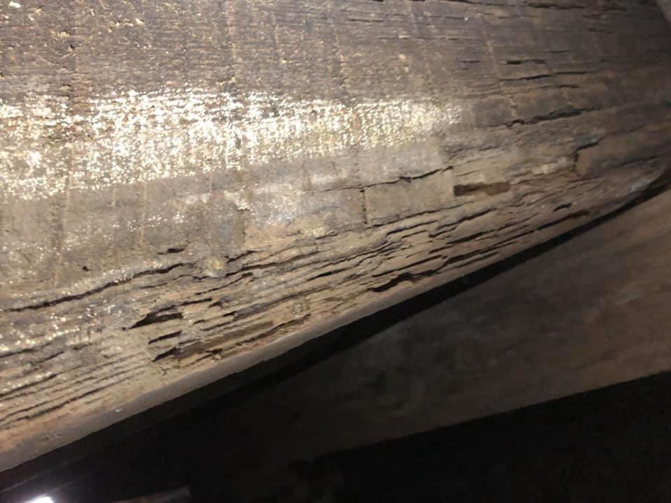 A severely damaged wooden beam, likely caused by pests, requiring remediation from Brandon Mcgowan in Little Rock, AR.