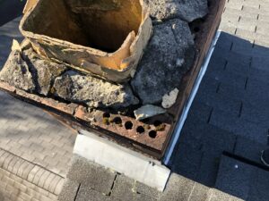 A severely damaged chimney top with a crumbling flue liner and masonry, requiring repair from Al's Chimney Sweep in Pittsburgh, PA.