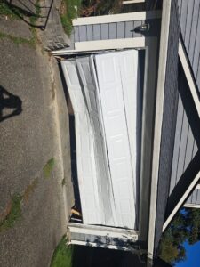 A severely damaged and collapsed garage door requiring urgent repair from Steadfast Garage Door Services LLC in Federal Way, WA.