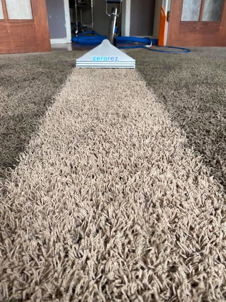 A Zerorez cleaning tool creating a clean path on a shaggy carpet, demonstrating professional service in Wichita, KS.