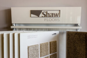 A display of Shaw Floors carpet samples at P&Q Flooring in Johns Creek, GA, for customer selection.