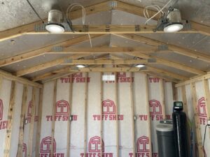 Interior of a shed showing electrical wiring, recessed lighting, and outlets installed by Sparks By Rabbit LLC in Scottsdale, AZ.