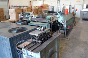 Sheet metal fabrication equipment and an HVAC unit in the workshop of Expert Air Conditioning & Heating in Las Vegas, NV.
