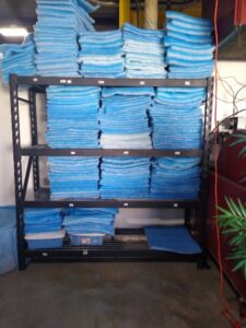 Shelves stacked with blue HVAC filter media at Murray Filter Sales and Service, Inc. in Nashville, TN