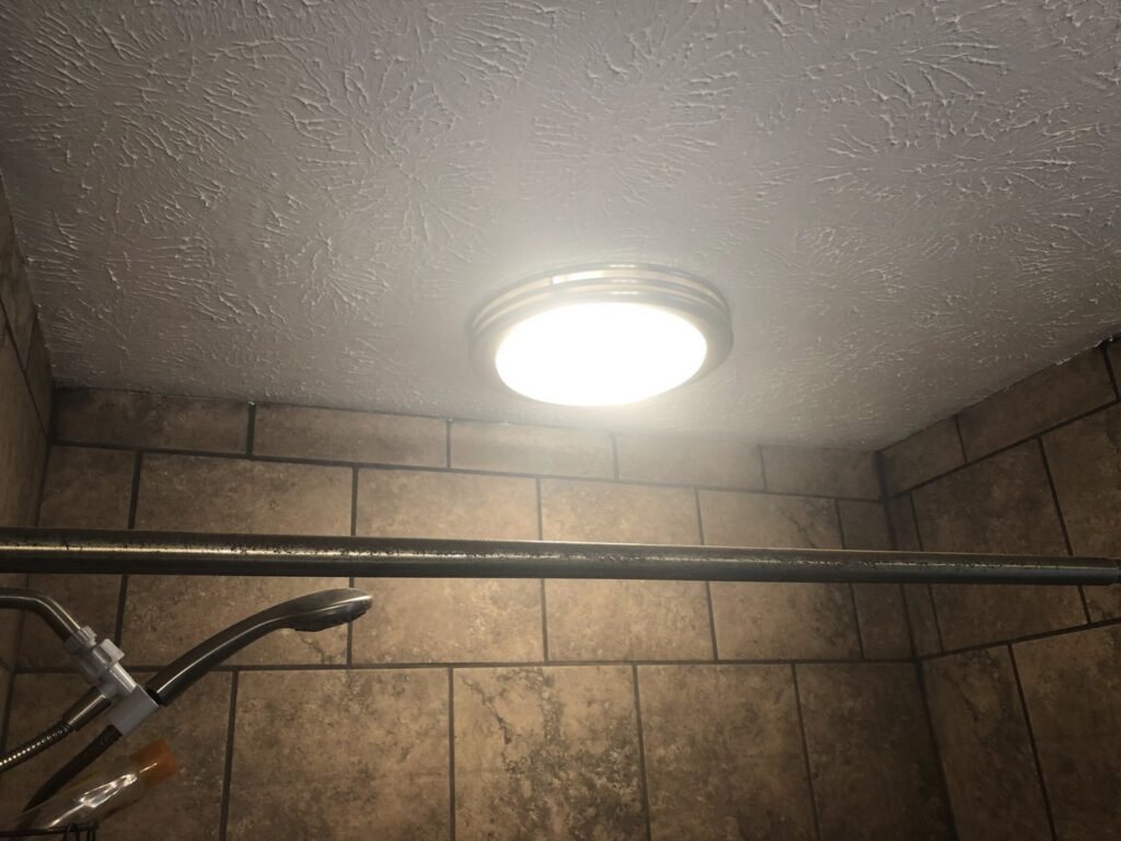A modern ceiling light fixture installed in a shower by TCB Electric LLC in Elizabethtown, KY.