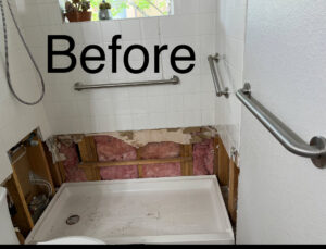A "Before" view of a shower renovation, showing exposed walls before tile installation by Carpet Planet LLC in Colorado Springs, CO.