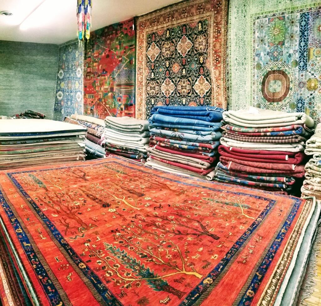 A vibrant showroom displaying a wide variety of tribal rugs, available at Yayla Tribal Rugs, Inc. in Cambridge, MA.