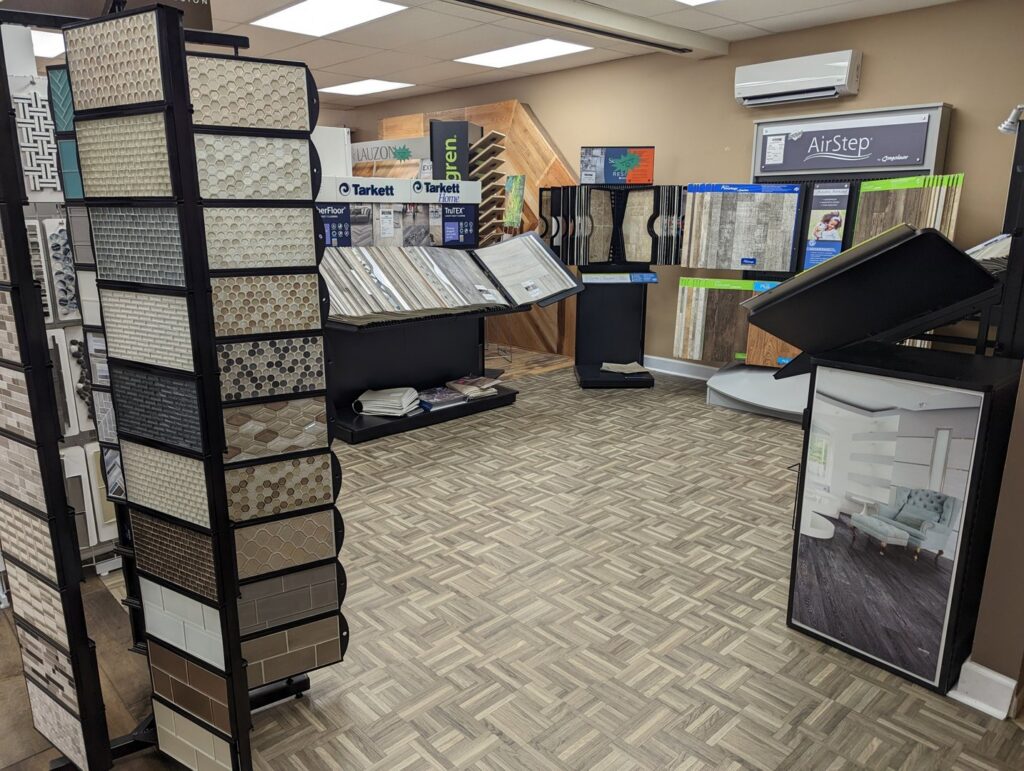 An interior view of the showroom displaying various tile and wood-look flooring options at Petersen's Carpet & Flooring in Frederick, MD