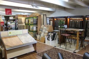 An inviting interior view of the Westcraft Flooring showroom, featuring a patterned carpet and various flooring displays in Denver, CO.
