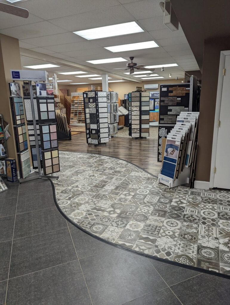 A wide selection of diverse flooring samples, including patterned tiles, displayed in the showroom at Petersen's Carpet & Flooring in Frederick, MD