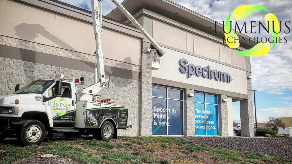 Lumenus Technologies, LLC performing sign repair and installation with a bucket truck in Lenexa, KS.