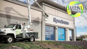 Lumenus Technologies, LLC performing sign repair and installation with a bucket truck in Lenexa, KS.