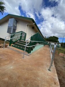 Silver metal handrails installed along green stairs and a ramp by A&D Services in Kapolei, HI.