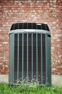A single outdoor HVAC unit positioned against a brick wall, representing services from My Mechanical Heating and Cooling in Lancaster, PA