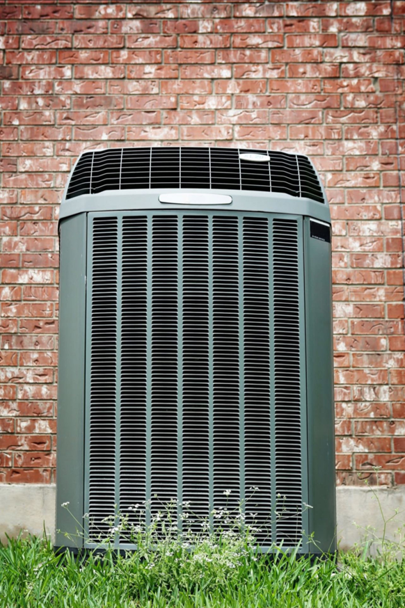 A single outdoor HVAC unit positioned against a brick wall, representing services from My Mechanical Heating and Cooling in Lancaster, PA