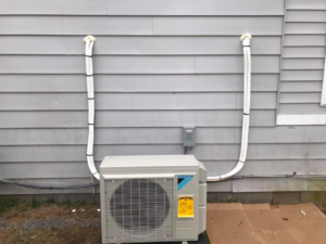 A single outdoor HVAC condenser unit professionally installed next to a home by Comfort Coach in Glade Hill, VA