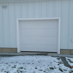 A single white panel garage door installed on a white building exterior, completed by Southcoast Overhead Door & Services in Fall River, MA.