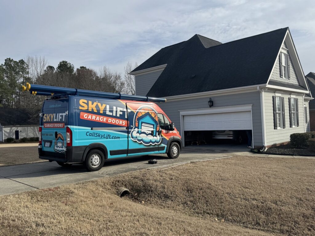 Skylift Garage Doors van parked at a residential home with an open garage door, indicating service in Knoxville, TN