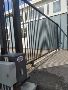 A sliding metal gate with an automatic gate opener mechanism installed by Automated Entry Systems Inc in Escondido, CA.