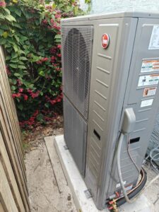 A slim outdoor HVAC unit installed next to a fence by QUICK AIR USA in Orlando, FL.