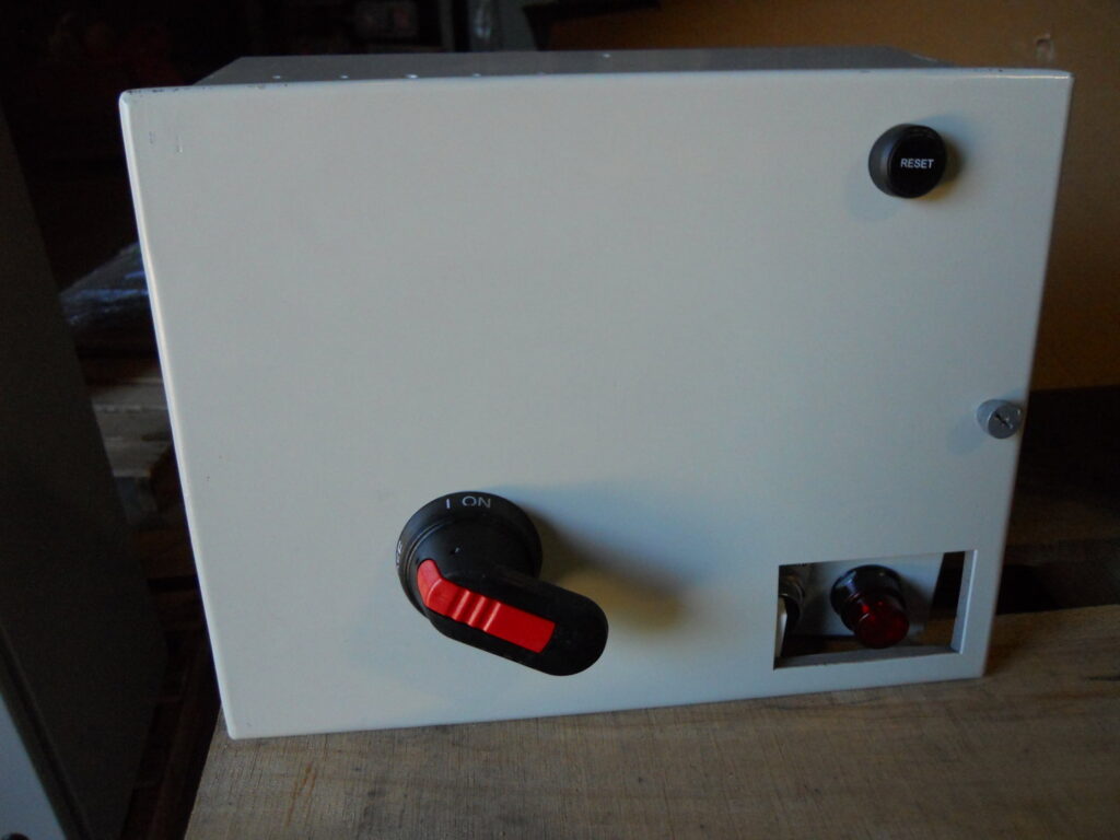 A small electrical disconnect box featuring a rotary switch and a reset button, supplied by Basic Supply in Lafayette, LA.