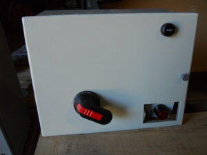 A small electrical disconnect box featuring a rotary switch and a reset button, supplied by Basic Supply in Lafayette, LA.