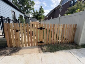 A small wood picket fence with a gate installed at a residential property by Cameron Fence Builders in Indianapolis, IN.