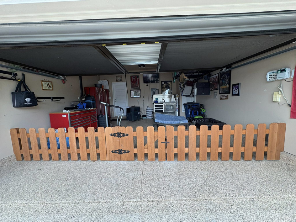 A small wooden picket fence with a gate, built by Olson Handyman Services, LLC in New Braunfels, TX