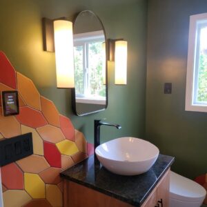 Smart home tablet and vanity lights installed in a modern bathroom by Watts Up Electric in Crystal Lake, IL.