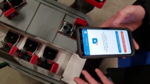 A technician using a smartphone to monitor smart pest traps for Biotech Pest Management in Summerville, SC.