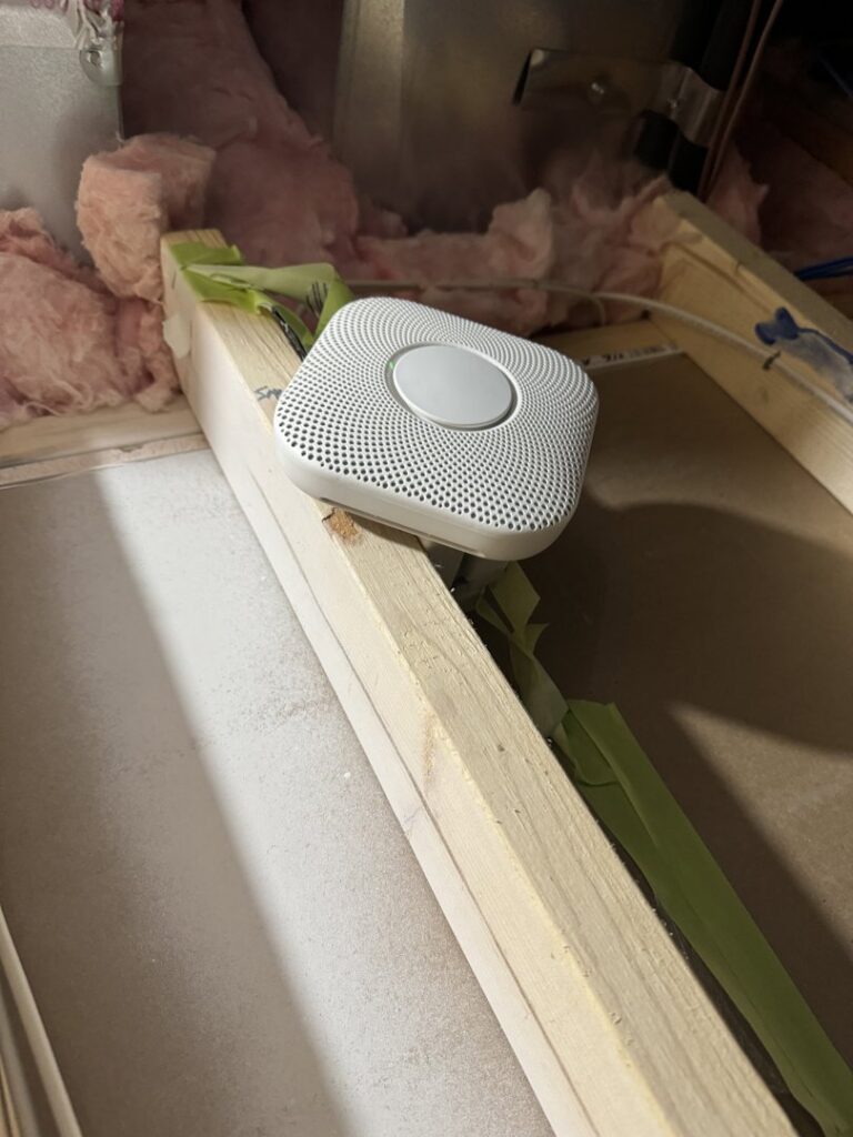 A smart smoke and carbon monoxide detector installed in an unfinished space by Mister Sparky Kansas City, MO.