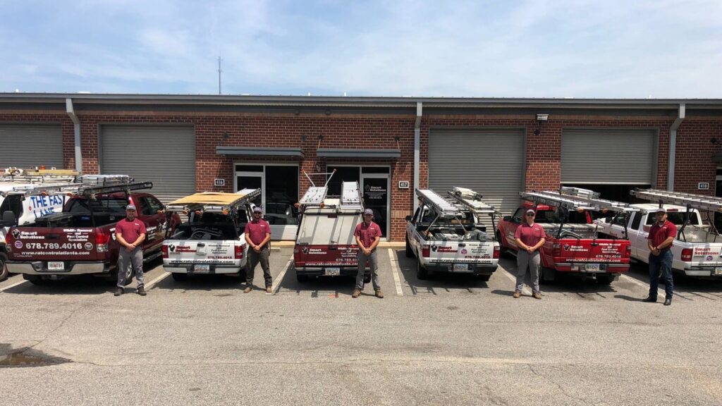 The Smart Solutions Wildlife Removal Specialists team and their fleet of service trucks in Roswell, GA.