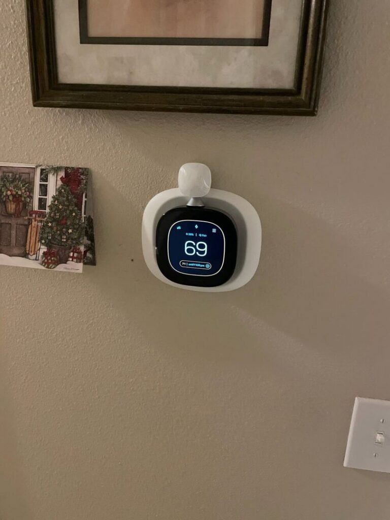 A modern smart thermostat displaying 69 degrees, installed by Advanced Home Services in Rigby, ID.