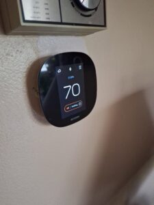 A smart Ecobee thermostat installed on a wall, representing HVAC control services by Nimmer Heating & Air Conditioning in Milwaukee, WI.