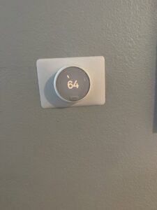 A smart thermostat installed on a wall by Genesis - Heating and Air Conditioning Specialist in SUNNYSIDE, NY