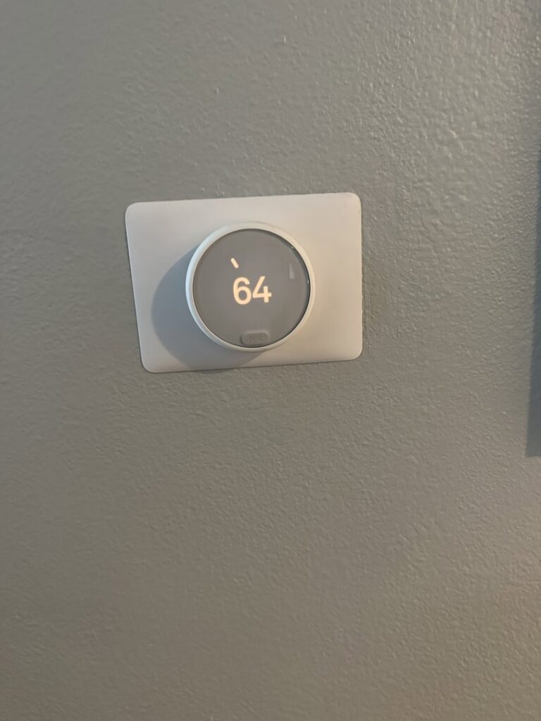 A smart thermostat installed on a wall by Genesis - Heating and Air Conditioning Specialist in SUNNYSIDE, NY