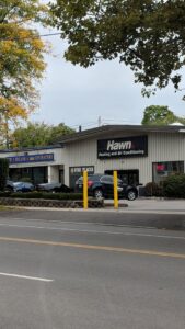 A modern smart thermostat installed on a wall, showcasing HVAC control services by Hawn Heating and Air Conditioning in Rochester, NY.