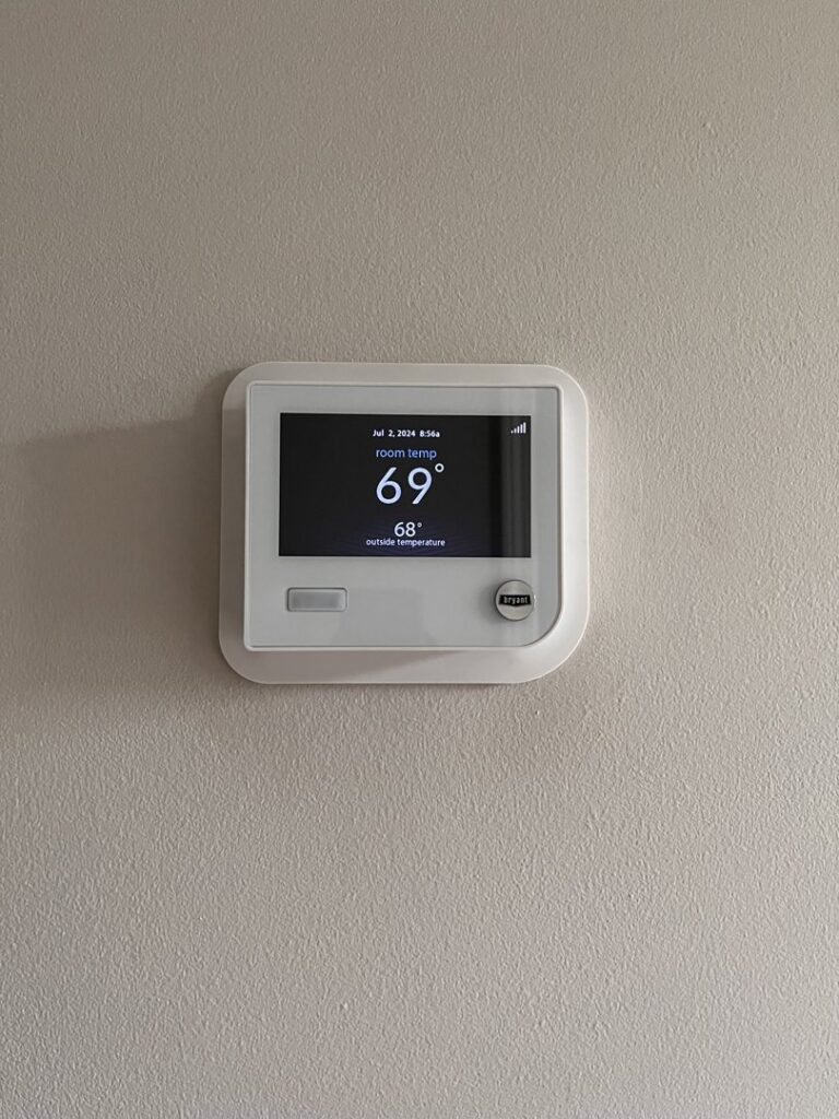 A smart thermostat displaying room temperature, installed by Kustom Heating & Cooling in Elgin, IL
