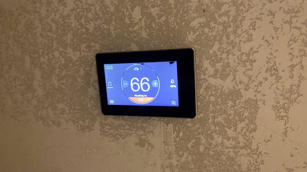 A modern smart thermostat displaying temperature settings, installed by The HVAC Doc in Rock Springs, WY